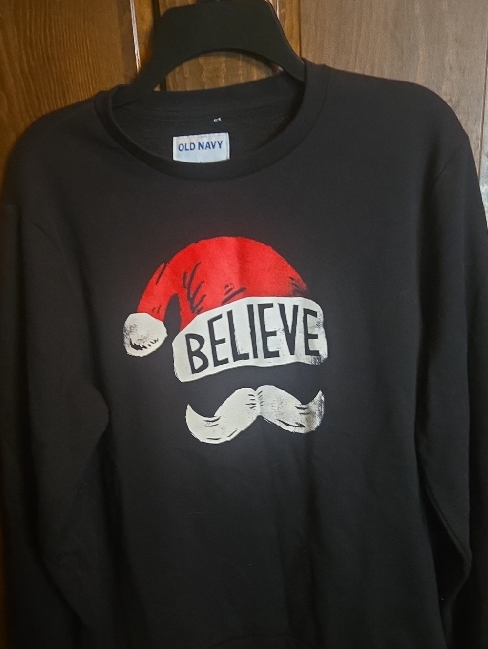 Old Navy Black Sweatshirt with Red Santa Hat and White 'Believe' Graphic